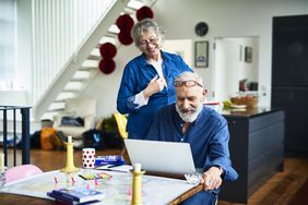 Happy older couple planning at a computer