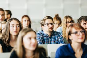 a classroom full of college students listening to a lecture