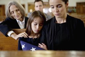 Mother and daughter at a funeral
