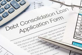 Debt Consolidation Loan Application Form with pen, calculator