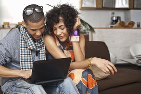 Couple looking over financial information on a computer