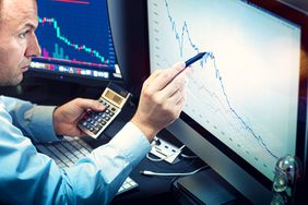Stockbroker analyzes the financial chart.