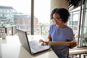 Woman in High-Rise Working at Laptop