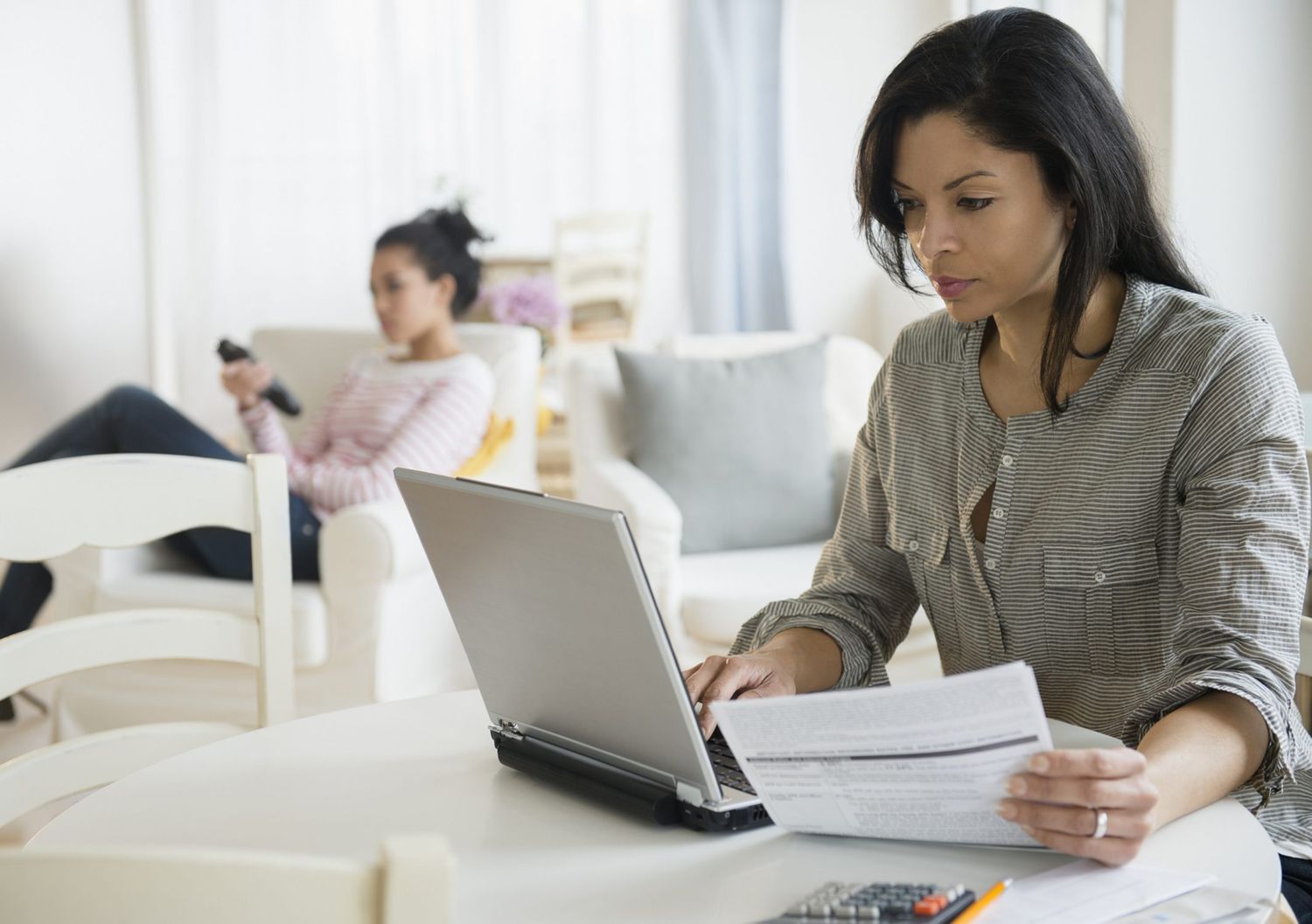 A picture of a mom paying her bill online