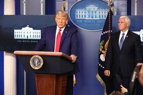 President Donald Trump delivers remarks as Vice President Mike Pence looks on.