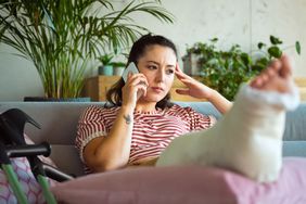 An injured person talks on the phone.