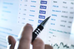 Hand of a stockbroker buying and selling shares online