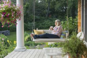 A person sits on a porch swing.
