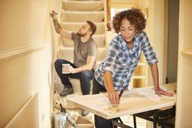  A man and woman renovating their home
