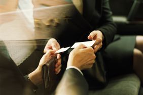 Businessman and woman exchanging business cards, close up