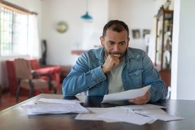 Person checking home finances and looking worried 