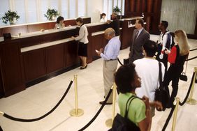 Bank customers wait in line to see a representative