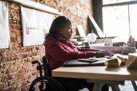 Woman in a wheelchair working on a laptop
