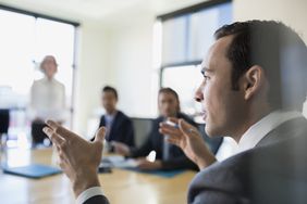 Close up businessman gesturing in conference room meeting