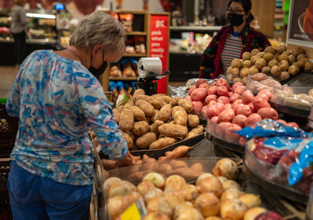 SOUTH BURLINGTON, VERMONT - JUNE 20: Shoppers look at a fresh vegetables display June 20, 2022 at the Market 32 Supermarket in South Burlington, Vermont. Prices for food in 2022 have increased nearly 10% since the same period in 2021.