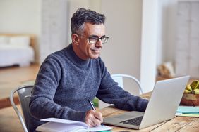 Shot of a mature businessman working from home