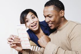 A couple looking happy after winning a lottery