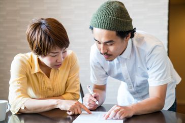 Man and woman filling out paperwork together