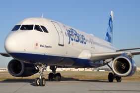 A JetBlue passenger plan sits on a runway.