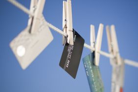 Credit cards hang from a clothesline