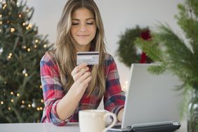Young woman using credit card during online shopping