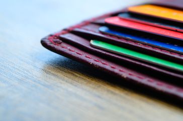 wallet with bank cards on wooden table