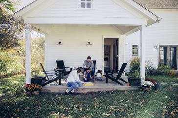Family spending time together on front porch of home