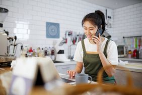 Small business owner on phone in bakery