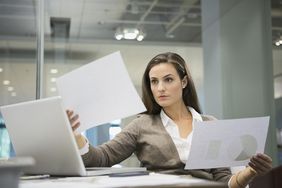 Businesswoman comparing documents