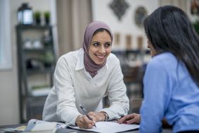 Two Muslim women working in their home office