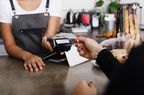 Woman making a credit card payment to a small business