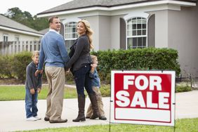 Family in front of house for sale