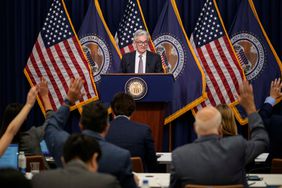 Fed Chair Jerome Powell addressing a press conference from a podium