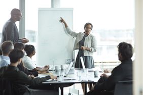 Businesswoman doing presentation in big boardroom - stock photo