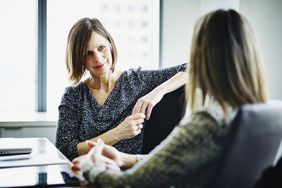 Mature businesswoman in discussion with colleague