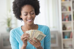 Happy woman counting money