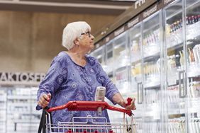 Senior woman doing shopping in supermarket.