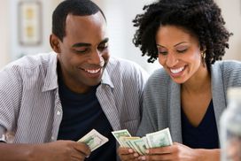 Smiling man and woman counting money