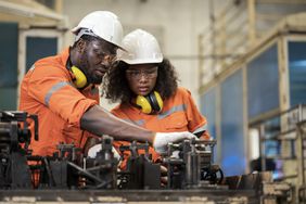 Man and woman discussing welding assembly process