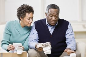 Mature couple reviewing receipts for income taxes