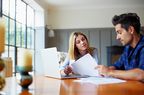 Couple going through some paperwork together at home