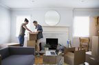 Couple in new home unpacking boxes