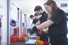 Apprentices working on training production line