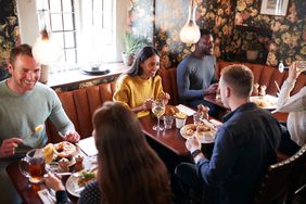 Diners enjoy a meal at a crowded pub.