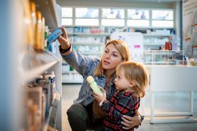 Mother and small child shopping in a drugstore