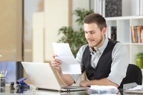 Businessman reading a letter at office