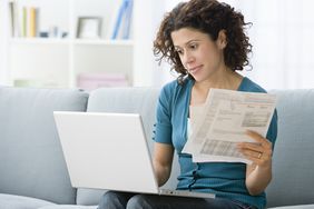 A woman reviews her credit card billing statement