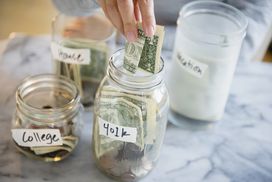 Hand putting money in to jars marked "college" and "401k"
