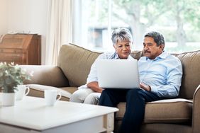 Older couple with laptop on couch