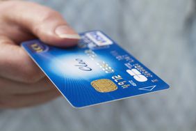 a person holding an unemployment debit card